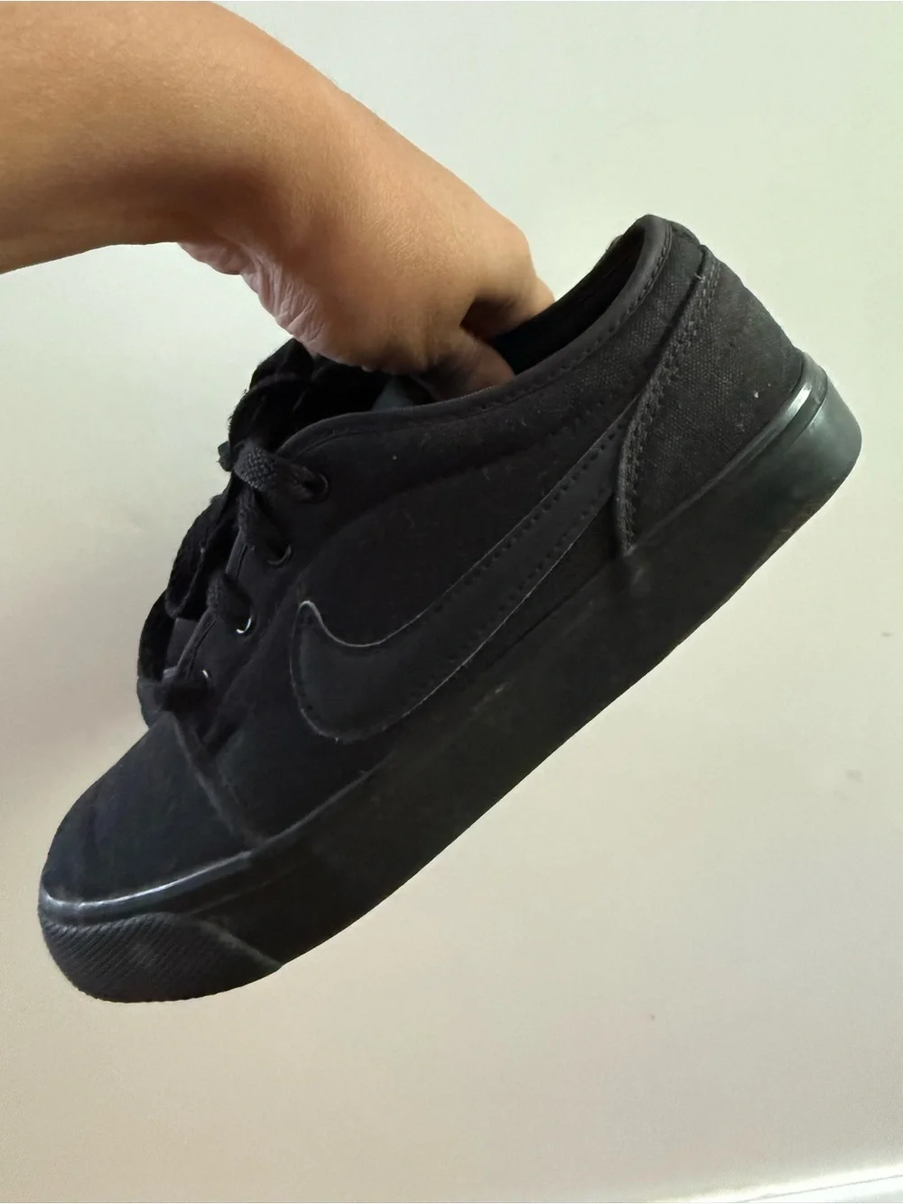 Nike Toki Low Triple Black canvas colorway (model number 555272-015) sneakers 4Y